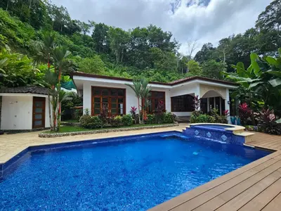 a villa with a swimming pool and a house at Villa Azulita in Tarcoles