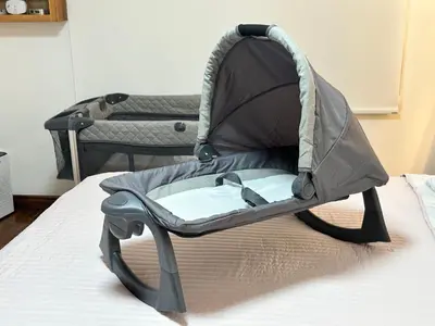 a baby car seat sitting on a bed at Rohrmoser Eucalipto Luxe Residence in San José