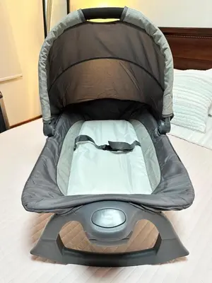 a baby car seat sitting on a bed at Rohrmoser Eucalipto Luxe Residence in San José