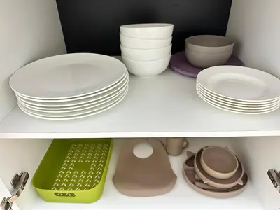 a shelf with plates and other dishes in a closet at Rohrmoser Eucalipto Luxe Residence in San José