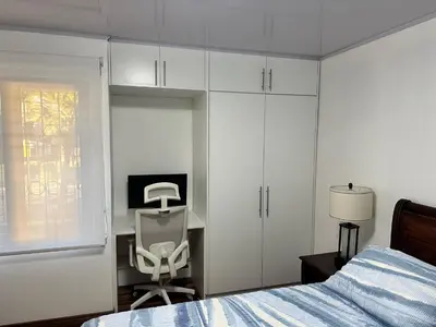 a bedroom with a bed and a desk and a chair at Rohrmoser Eucalipto Luxe Residence in San José