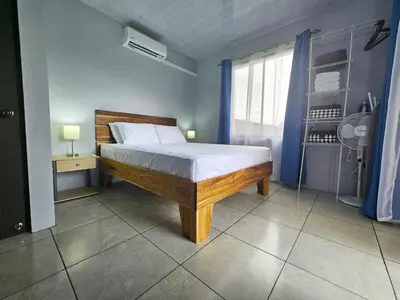 a bedroom with a bed and a window at Casa Vista Arenal in Fortuna
