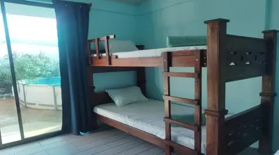 two bunk beds in a room with a window at Villa Blue Vacations in Parrita