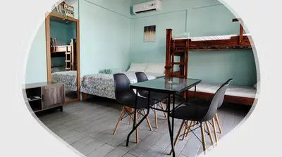 a room with a table and chairs and a bunk bed at Villa Blue Vacations in Parrita