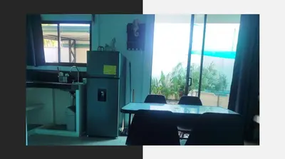 a kitchen with a table and chairs and a refrigerator at Villa Blue Vacations in Parrita