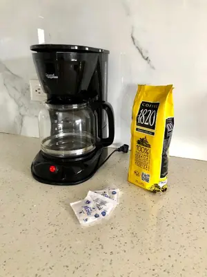 a black coffee maker sitting on a counter with a bag of chips at Near from Beach- Cozy Herradura Tropical home in Herradura