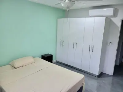a bedroom with a bed and white cabinets at Near from Beach- Cozy Herradura Tropical home in Herradura