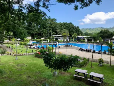 a park with a swimming pool and picnic tables at Near from Beach- Cozy Herradura Tropical home in Herradura