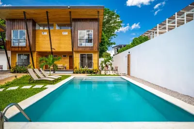 a swimming pool in the backyard of a home with a house at Macondo Ecolodge Apt 4 - Estrella de Fuego in Coco