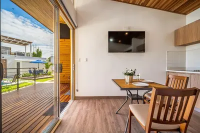 a kitchen and dining room with a dining table and a balcony at Macondo Ecolodge Apt 4 - Estrella de Fuego in Coco