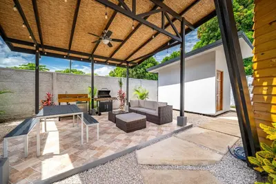 an outdoor patio with a wooden pergola at Macondo Ecolodge Apt 3 - Guaria Morada in Coco
