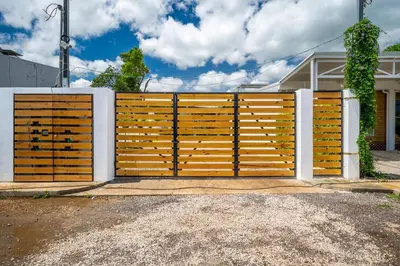 a wooden gate in front of a house at Macondo Ecolodge Apt 3 - Guaria Morada in Coco