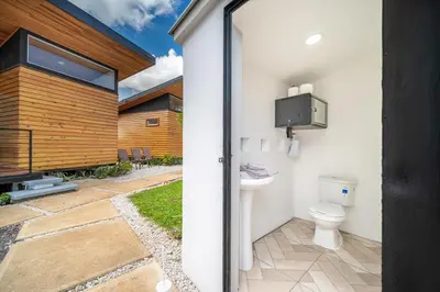 a bathroom with a toilet in a backyard at Macondo Ecolodge Apt 3 - Guaria Morada in Coco