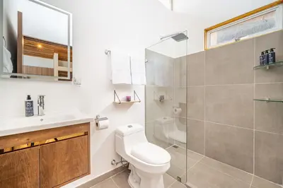 a bathroom with a toilet and a sink and a shower at Macondo Ecolodge Apt 3 - Guaria Morada in Coco