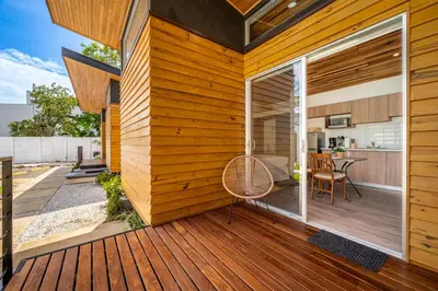 a wooden deck with a sliding glass door on a house at Macondo Ecolodge Apt 3 - Guaria Morada in Coco