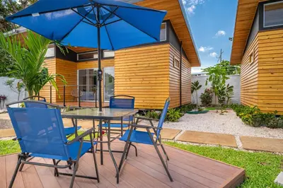 a table and chairs with an umbrella on a patio at Macondo Ecolodge Apt 3 - Guaria Morada in Coco