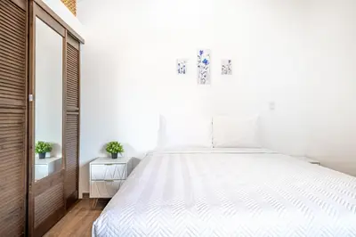 a bedroom with a large bed with white sheets at Macondo Ecolodge Apt 2 - Bromelia in Coco