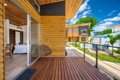 a house with a wooden deck with a bed at Macondo Ecolodge Apt 2 - Bromelia in Coco