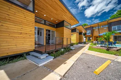 a house with a deck on the side of it at Macondo Ecolodge Apt 2 - Bromelia in Coco