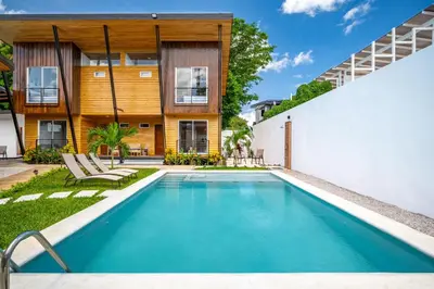a swimming pool in front of a house at Macondo Ecolodge Apt 2 - Bromelia in Coco
