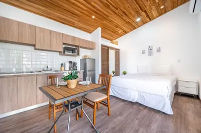a kitchen and a bedroom with a bed and a table at Macondo Ecolodge Apt 2 - Bromelia in Coco
