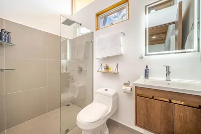 a bathroom with a toilet and a sink at Macondo Ecolodge Apt 5 - Alpinias in Coco
