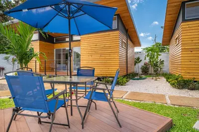 a table and chairs with an umbrella on a patio at Macondo Ecolodge Apt 5 - Alpinias in Coco