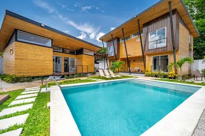 a house with a swimming pool in front of it at Macondo Ecolodge Apt 5 - Alpinias in Coco