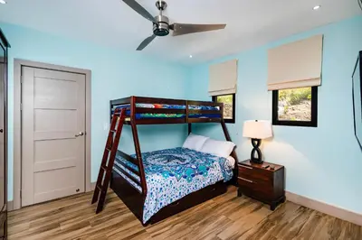 a bedroom with a bunk bed and a ceiling fan at Serene Oceanview Villa with Pool in Playa Flamingo