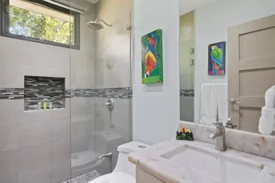 a bathroom with a sink and a toilet and a shower at Serene Oceanview Villa with Pool in Playa Flamingo