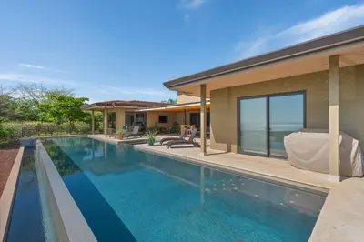 a swimming pool in the backyard of a house at Serene Oceanview Villa with Pool in Playa Flamingo