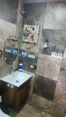a bathroom with a sink and a mirror at Ecohacienda Perla Marina in Sardinal