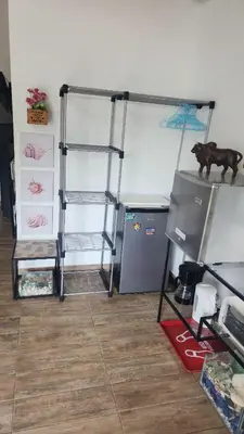 a room with two bunk beds and a refrigerator at Ecohacienda Perla Marina in Sardinal
