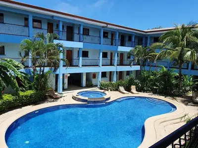 a swimming pool in front of a building at Apart Hotel Marina Loft 101 in Coco