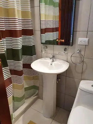 a bathroom with a sink and a shower curtain at Apart Hotel Marina Loft 101 in Coco