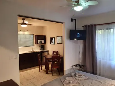 a kitchen and dining room with a table and a ceiling fan at Apart Hotel Marina Loft 101 in Coco