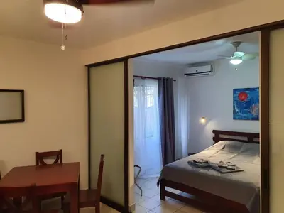 a bedroom with a bed and a table and a mirror at Apart Hotel Marina Loft 101 in Coco