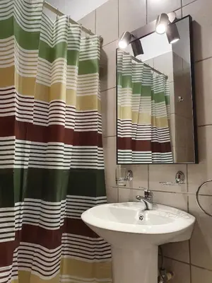 a bathroom with a sink and a shower curtain at Apart Hotel Marina Loft 101 in Coco