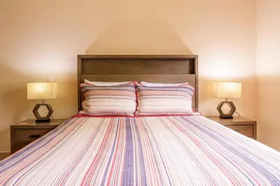 a bedroom with a large bed with two lamps at Casa Mimi - Beautiful House In Surfside in Potrero