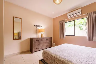 a bedroom with a bed and a dresser and a window at Casa Mimi - Beautiful House In Surfside in Potrero
