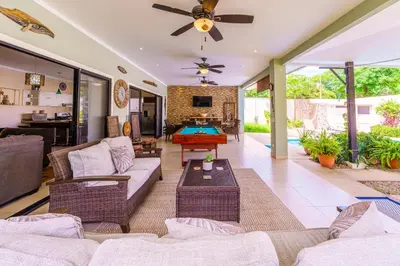 a living room with couches and a pool table at Casa Mimi - Beautiful House In Surfside in Potrero
