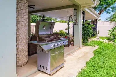 a outdoor kitchen with a grill on a patio at Casa Mimi - Beautiful House In Surfside in Potrero