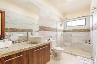 a bathroom with a shower and a sink and a toilet at Casa Mimi - Beautiful House In Surfside in Potrero