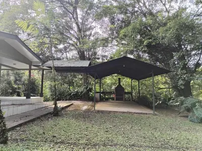a black pavilion with a statue in a yard at Mini reserva La Naciente Mi casa es tu casa in Tapantí