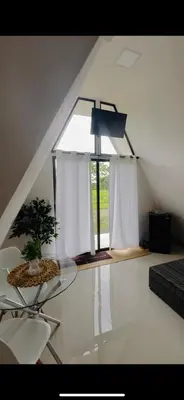 a room with a glass table and a window at Moonlight Lodge in Cuatro Esquinas