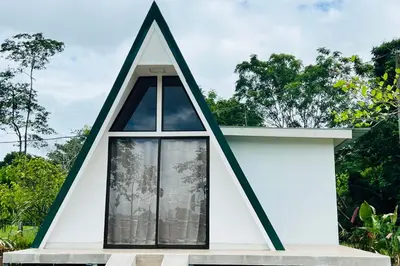 a triangular house with a window at Moonlight Lodge in Cuatro Esquinas