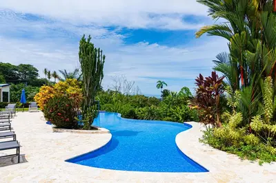 a swimming pool in the middle of a resort at Unique panoramic view and Central location! in Uvita