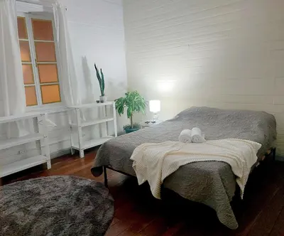 a bedroom with a bed with two stuffed animals on it at Vintage and Colonial House - 7min from Airport in Alajuela City