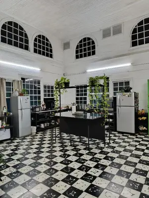 a kitchen with a black and white checkered floor at Vintage and Colonial House - 7min from Airport in Alajuela City