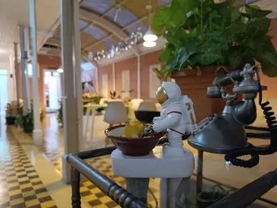 a figurine of a person eating food in a bowl at Vintage and Colonial House - 7min from Airport in Alajuela City